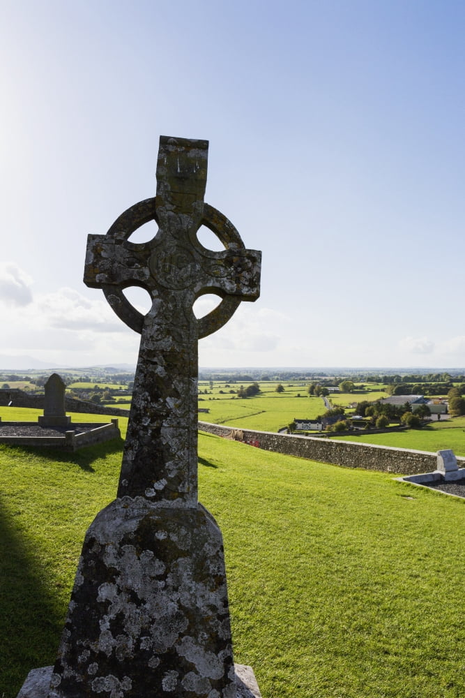 Posterazzi Celtic cross on grassy hill with stone wall under blue sky Cashel County Tipperary Ireland Canvas Art - Michael Interisano Design Pics (24 x 38)