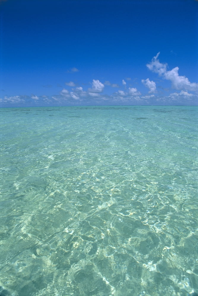 Posterazzi Clear Turquoise Ocean Water Blue Sky White Clouds Sunlight Reflections Canvas Art - Greg Vaughn Design Pics (24 x 38)