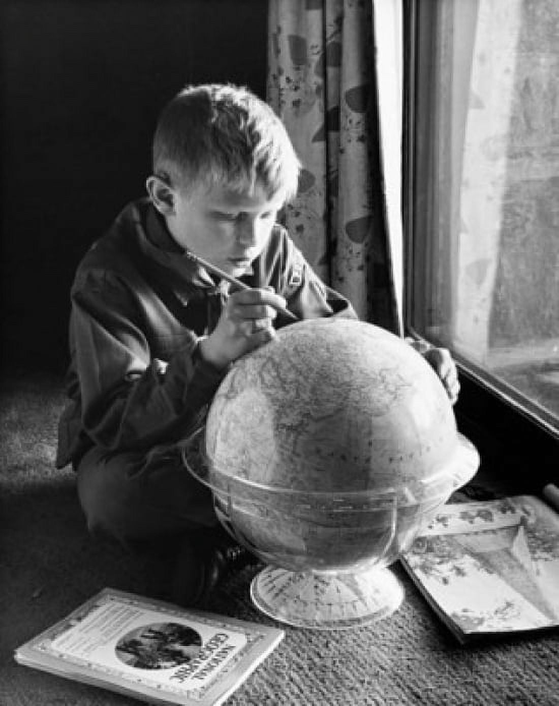 Posterazzi Close-up of a boy holding a pencil and marking on a globe Canvas Art - (24 x 36)