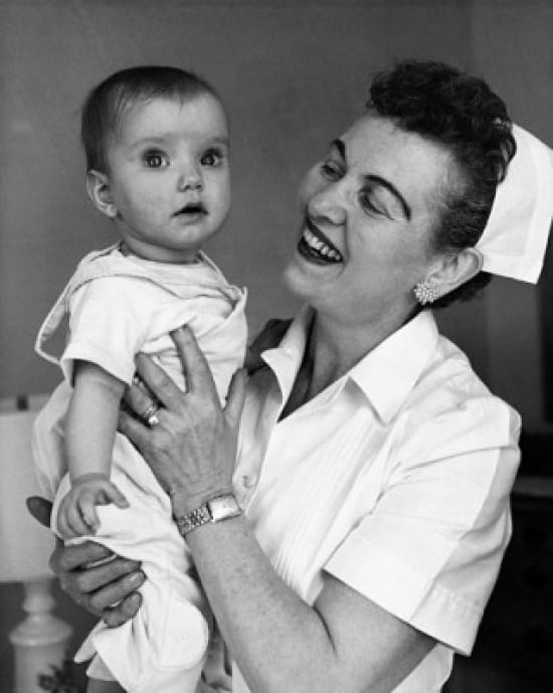 Posterazzi Close-up of a female nurse carrying a baby and smiling Canvas Art - (24 x 36)