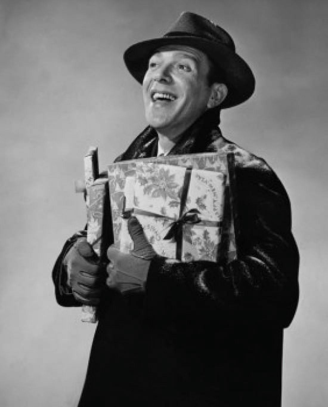 Posterazzi Close-up of a mid adult man holding Christmas presents and smiling Canvas Art - (24 x 36)