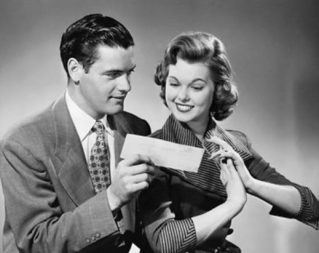 Posterazzi Close-up of a young man showing a check to a young woman Canvas Art - (24 x 36)