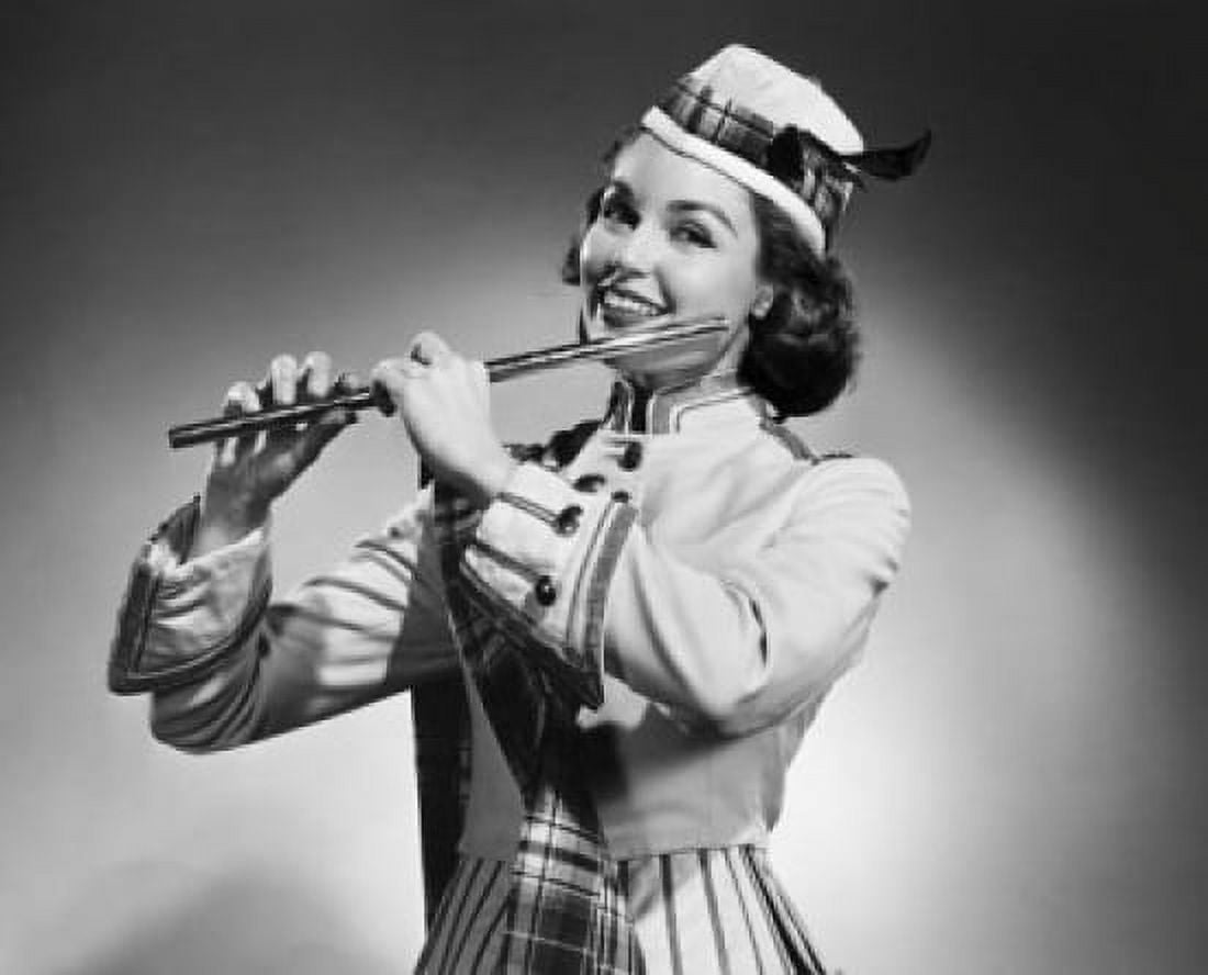 Posterazzi Close-up of a young woman holding a flute and smiling Canvas Art - (24 x 36)