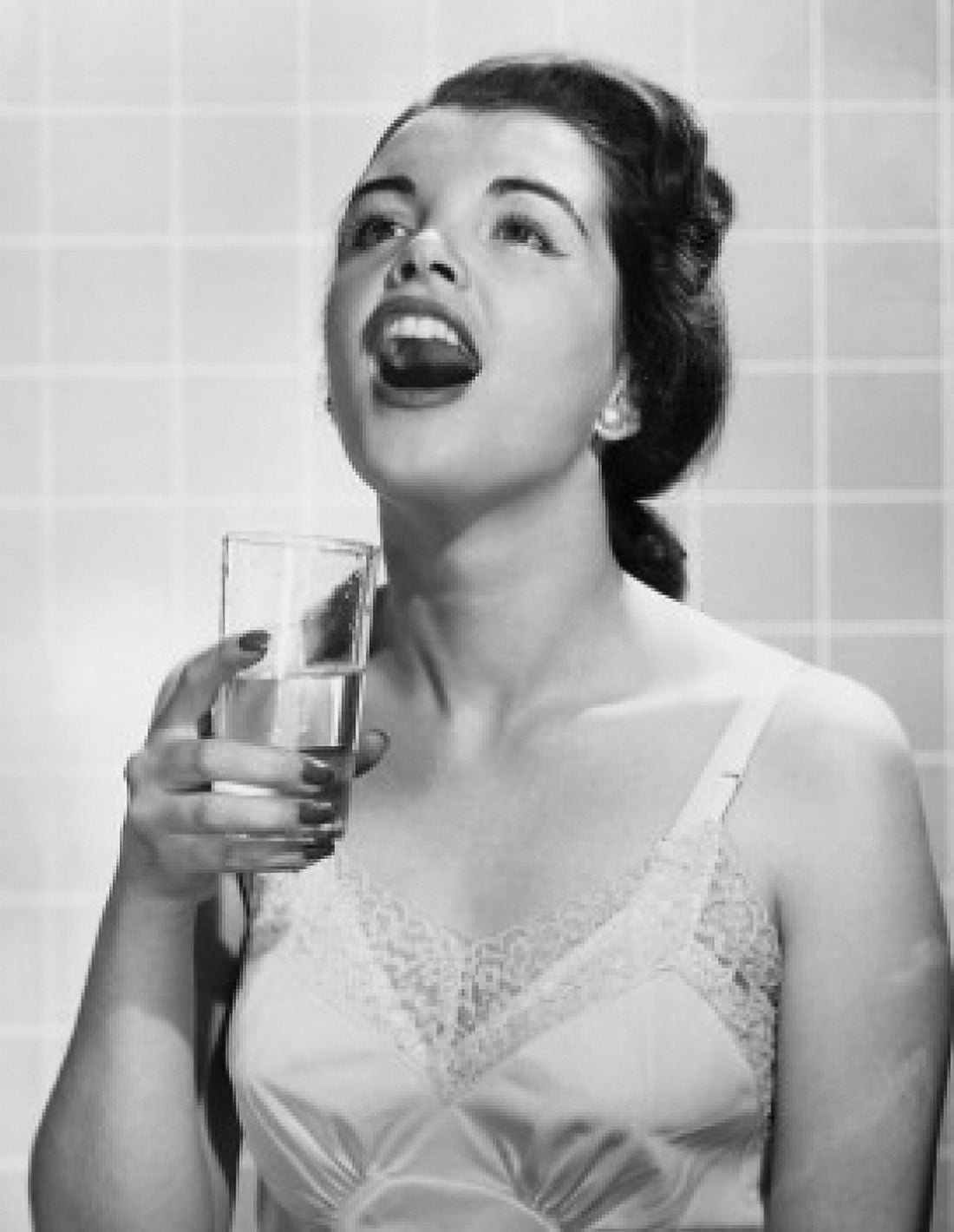 Posterazzi Close-up of a young woman holding a glass of water and gargling Canvas Art -  (24 x 36)