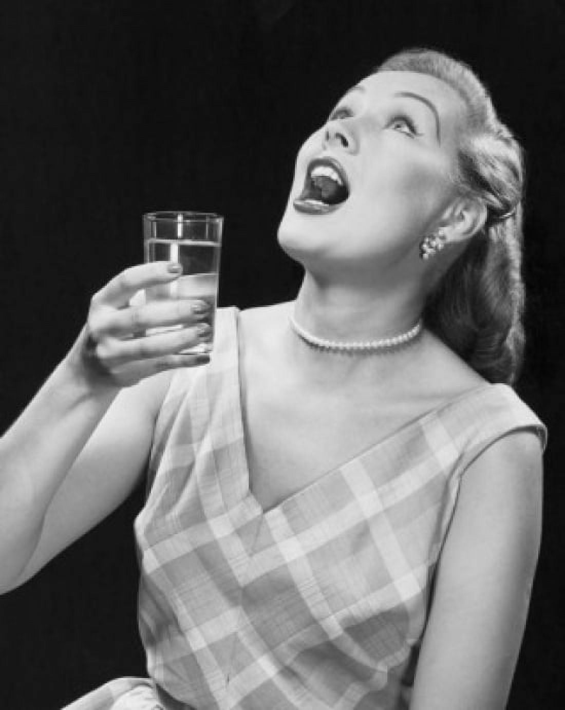 Posterazzi Close-up of a young woman holding a glass of water and gargling Canvas Art - (24 x 36)