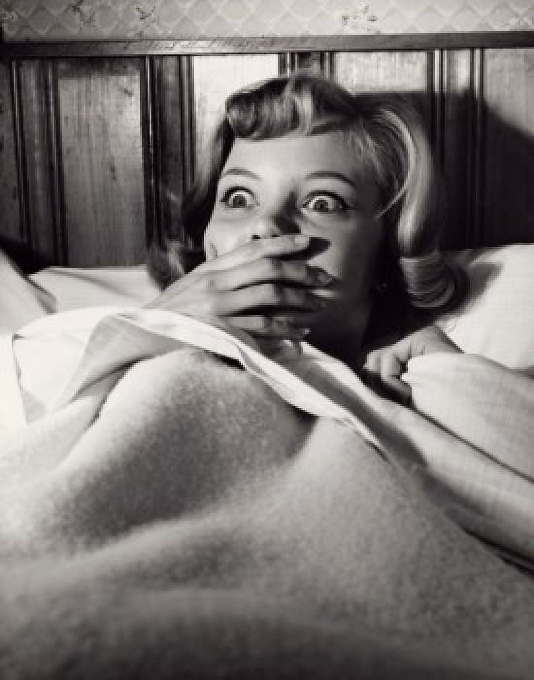 Posterazzi Close-up of a young woman lying in bed looking frightened Canvas Art - (24 x 36)