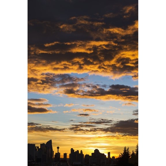 Posterazzi DPI12290270 Dramatic Colorful Clouds At Sunrise with Cityscape & Tree Silhouette - Calgary Alberta Canada Poster Print by Michael Interisano, 12 x 19