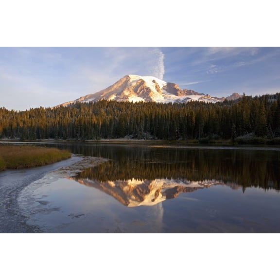 Washington, United States Of America; Reflection Of Mount Rainier In A Lake With Ice On The Surface In Mt. Rainier National Park Poster Print (19 x 12)
