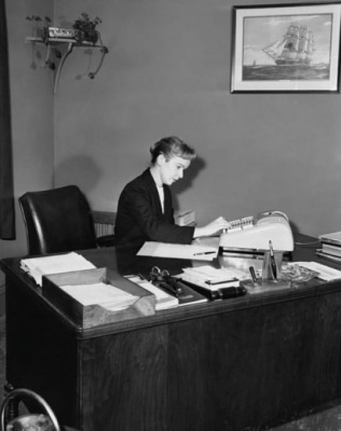 Posterazzi Executive accountant using an adding machine in an office Canvas Art - (24 x 36)