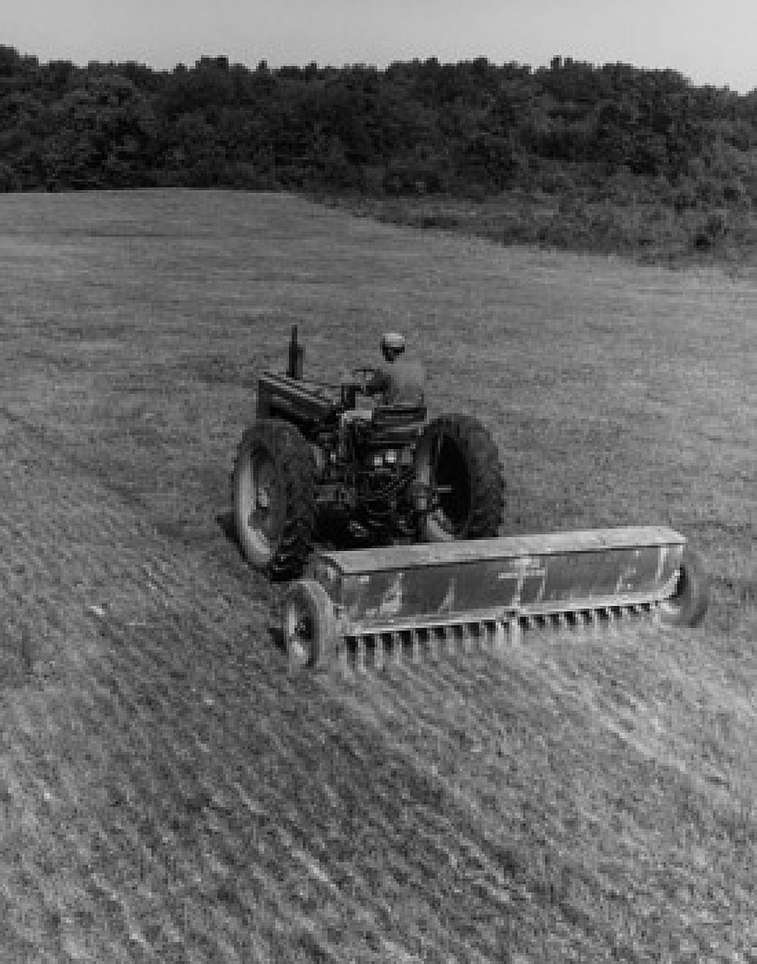 Posterazzi Farmer fertilizing the crop with a tractor Canvas Art - (24 x 36)