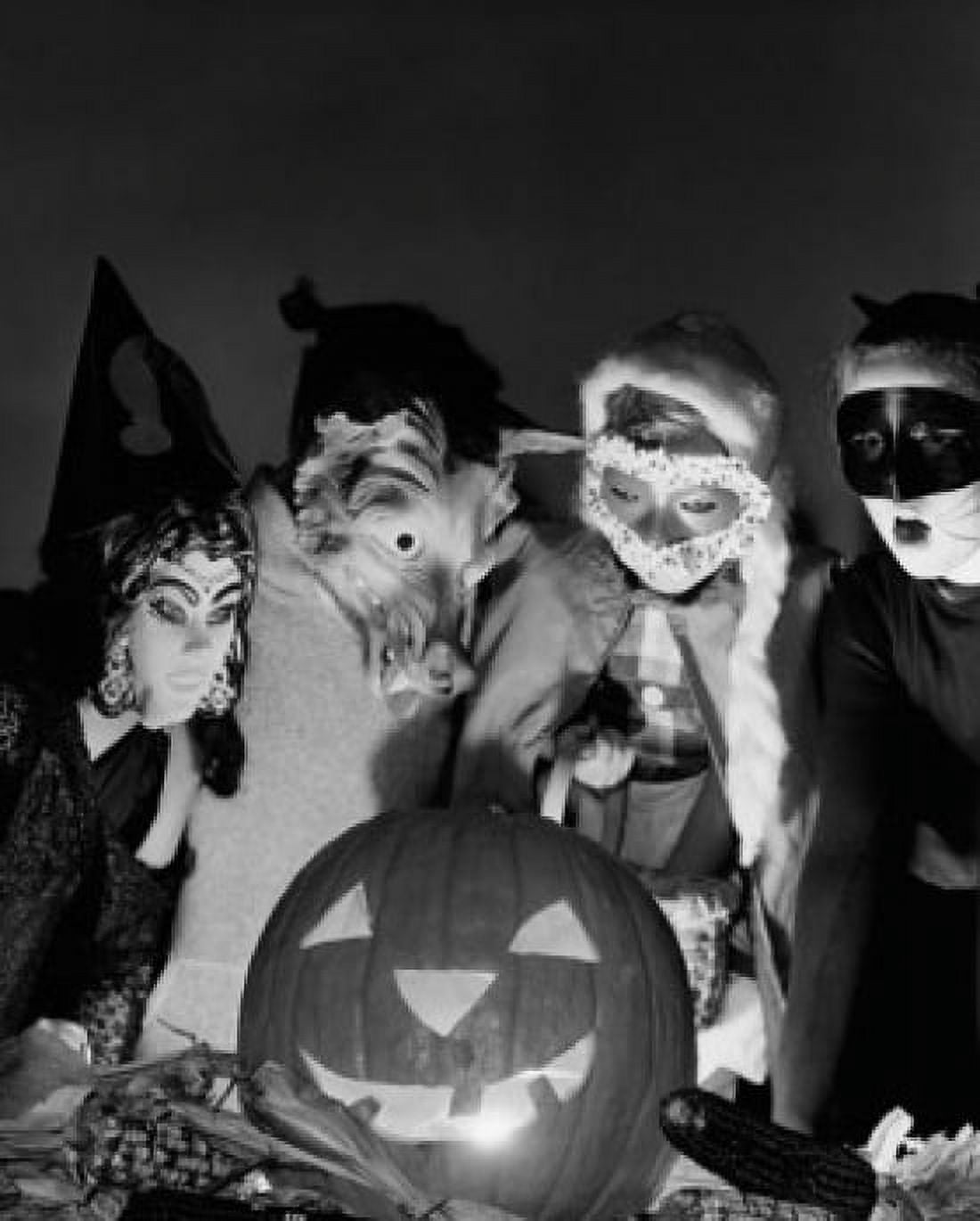 Posterazzi Four children wearing Halloween costumes looking at an illuminated jack o lantern Canvas Art - (24 x 36)
