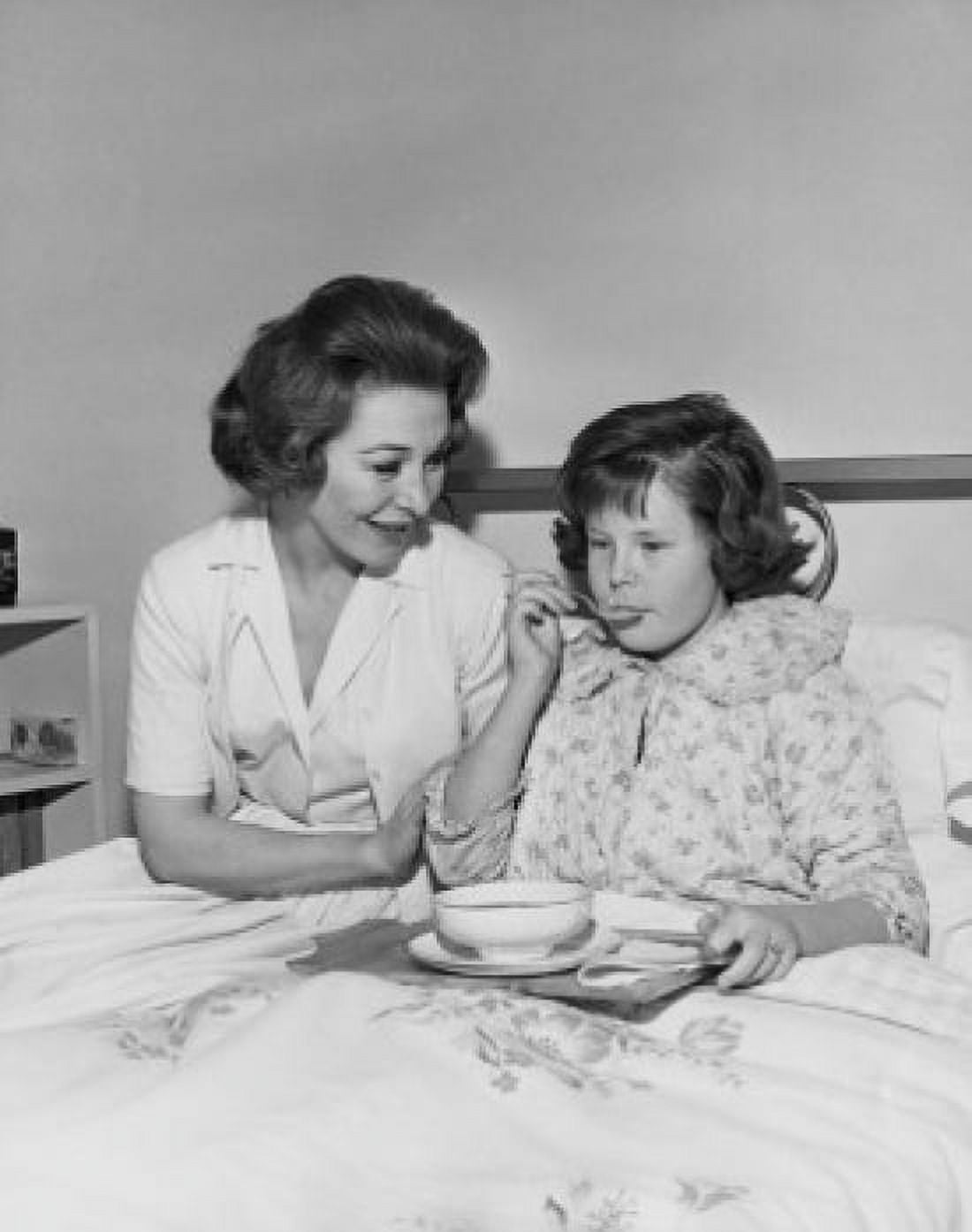 Posterazzi Girl eating food with a female nurse sitting beside her Canvas Art - (24 x 36)