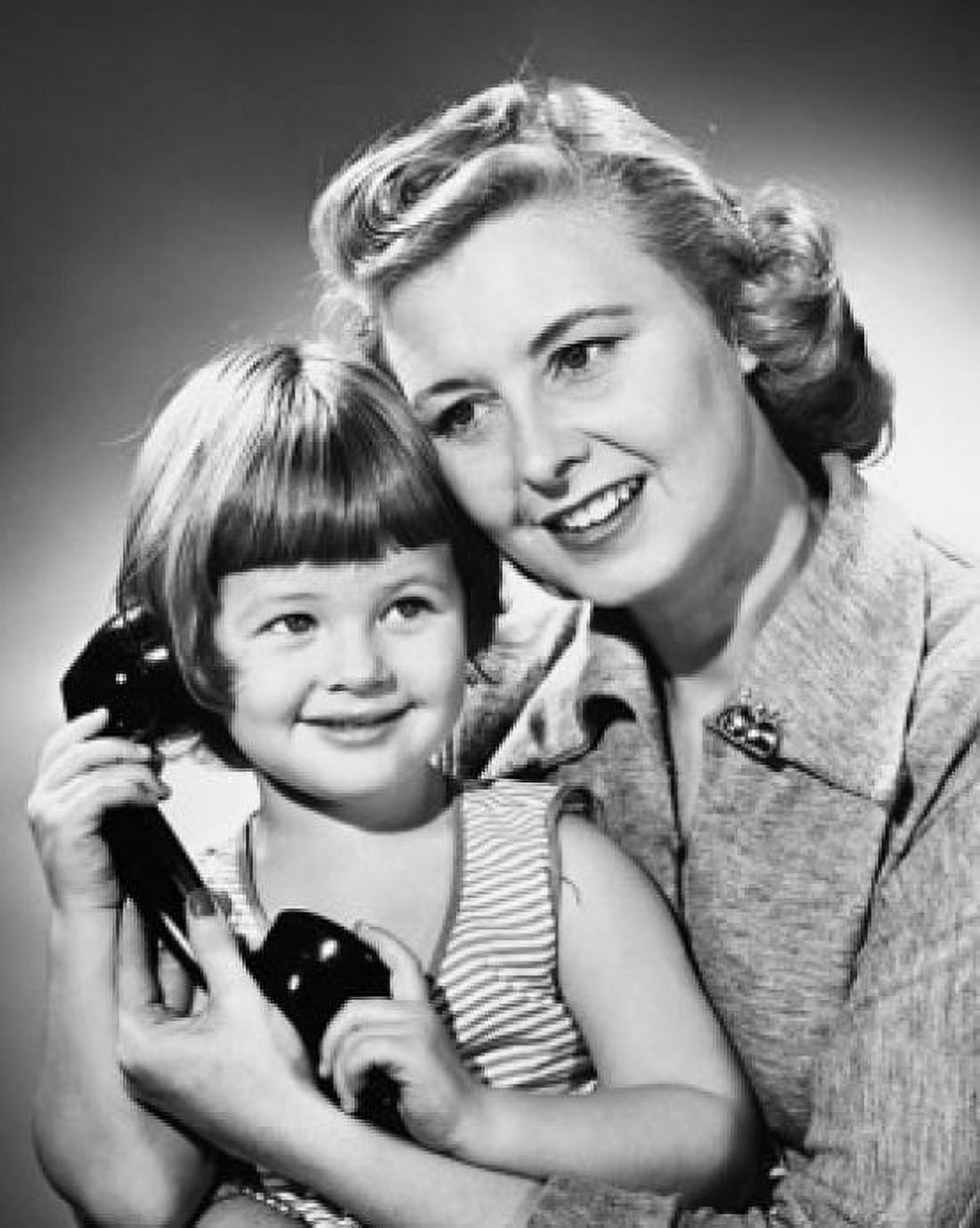 Posterazzi Girl holding a telephone receiver and smiling with her mother Canvas Art -  (24 x 36)