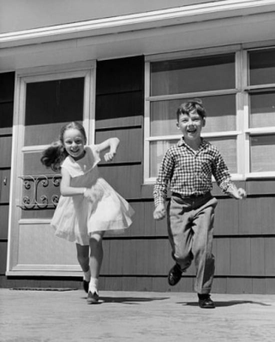 Posterazzi Girl running with her brother and smiling Canvas Art - (24 x 36)