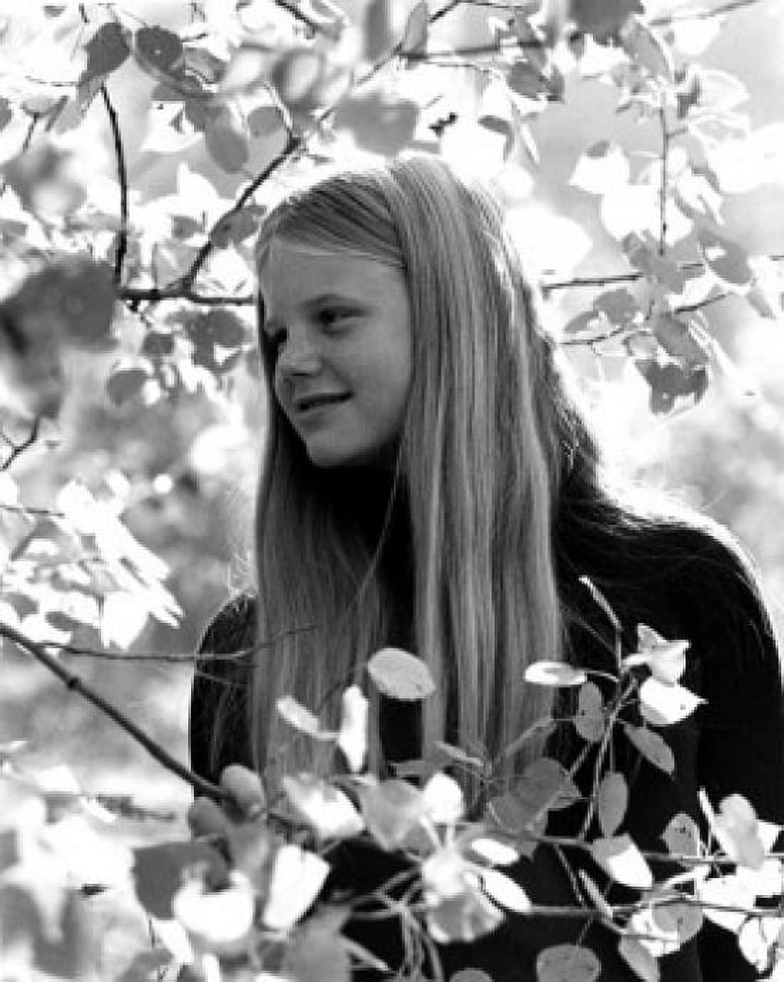 Posterazzi Girl standing among leaves on tree Canvas Art - (24 x 36)