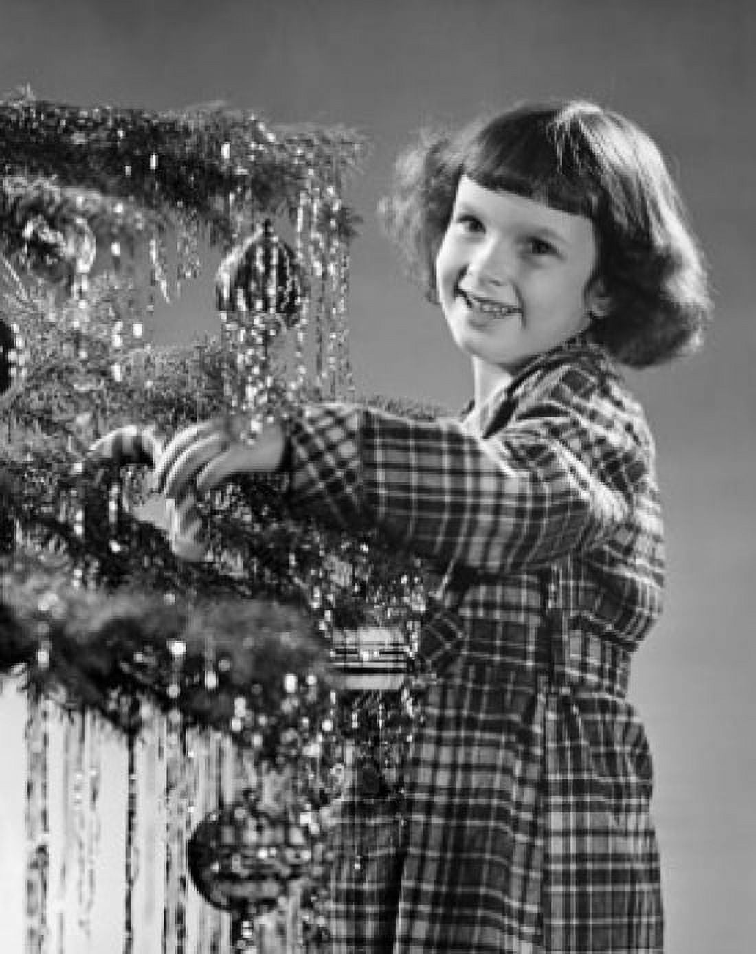 Posterazzi Girl standing near a Christmas tree and smiling Canvas Art - (24 x 36)