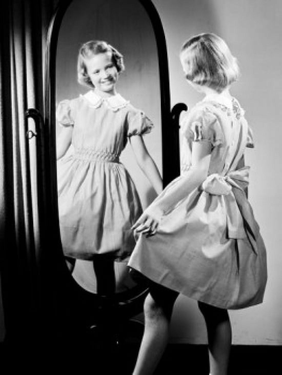 Posterazzi Girl trying on dress in front of mirror Canvas Art -  (24 x 36)