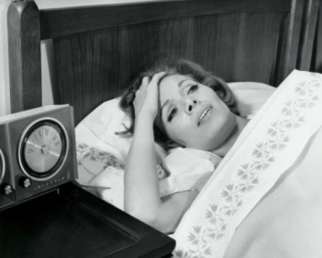Posterazzi High angle view of a mid adult woman lying in bed suffering from a headache Canvas Art - (24 x 36)