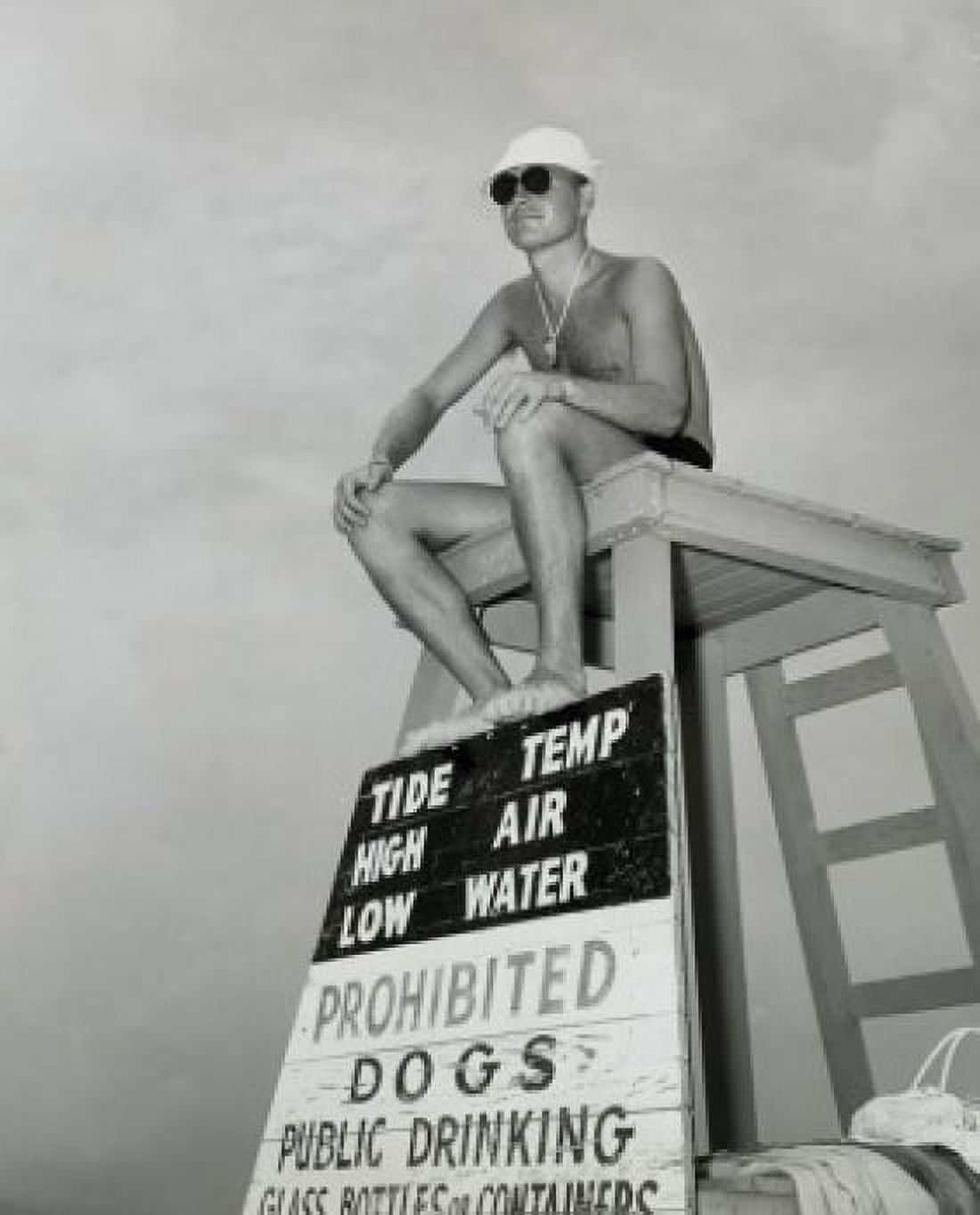 Posterazzi Low angle view of a young man sitting on a lifeguards chair Canvas Art - (24 x 36)