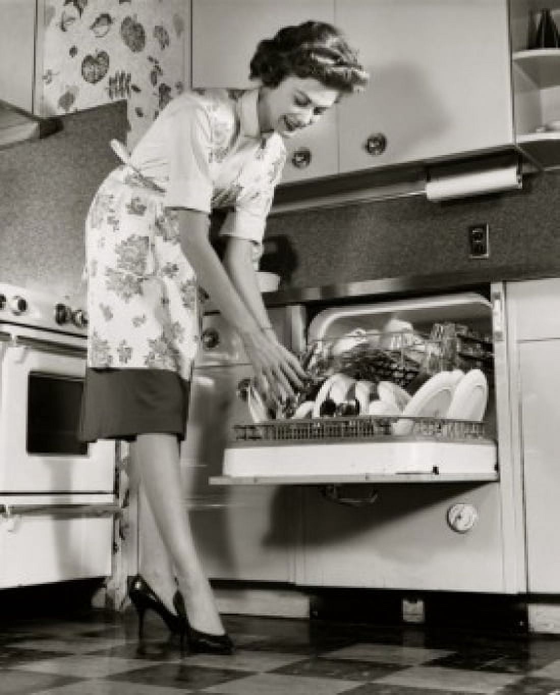 Posterazzi Low angle view of a young woman picking up a spoon from a dishwasher Canvas Art -  (24 x 36)