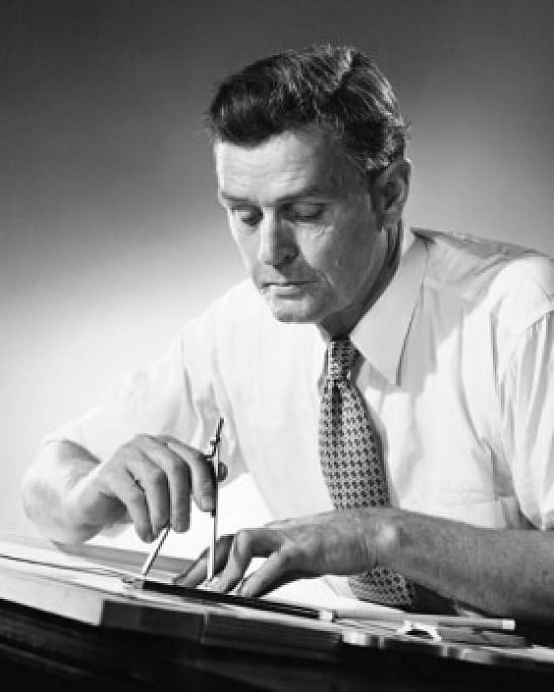 Posterazzi Male architect sitting at a table and drawing a blueprint Canvas Art - (24 x 36)