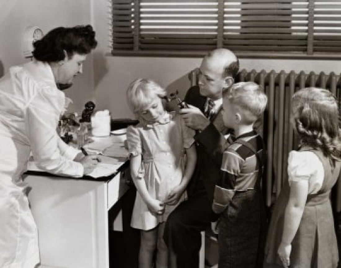 Posterazzi Male doctor examining a girls ear with an otoscope Canvas Art -  (24 x 36)
