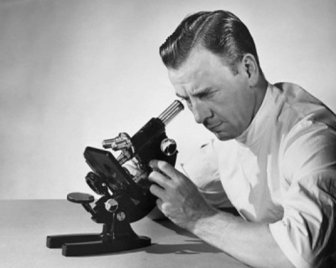 Posterazzi Male researcher looking through a microscope Canvas Art -  (24 x 36)