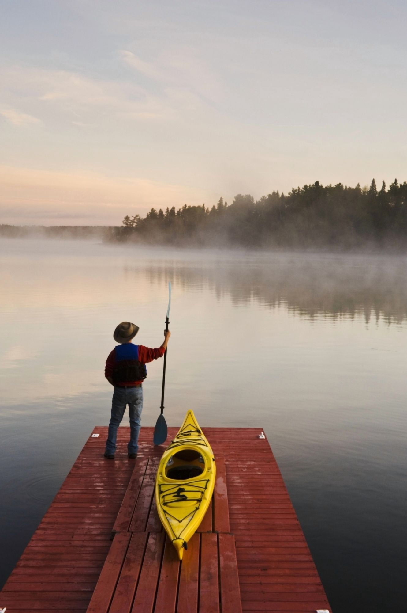 Posterazzi Man Standing By Kayak On Dock In Northwestern Ontario Lake Of The Woods Ontario Canada Canvas Art - Dave Reede Design Pics (24 x 36)