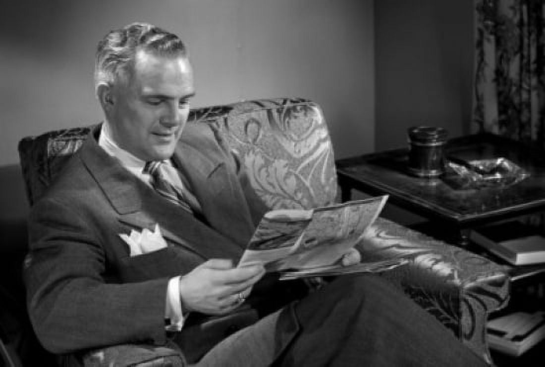 Posterazzi Man reading magazine in chair Canvas Art - (24 x 36)