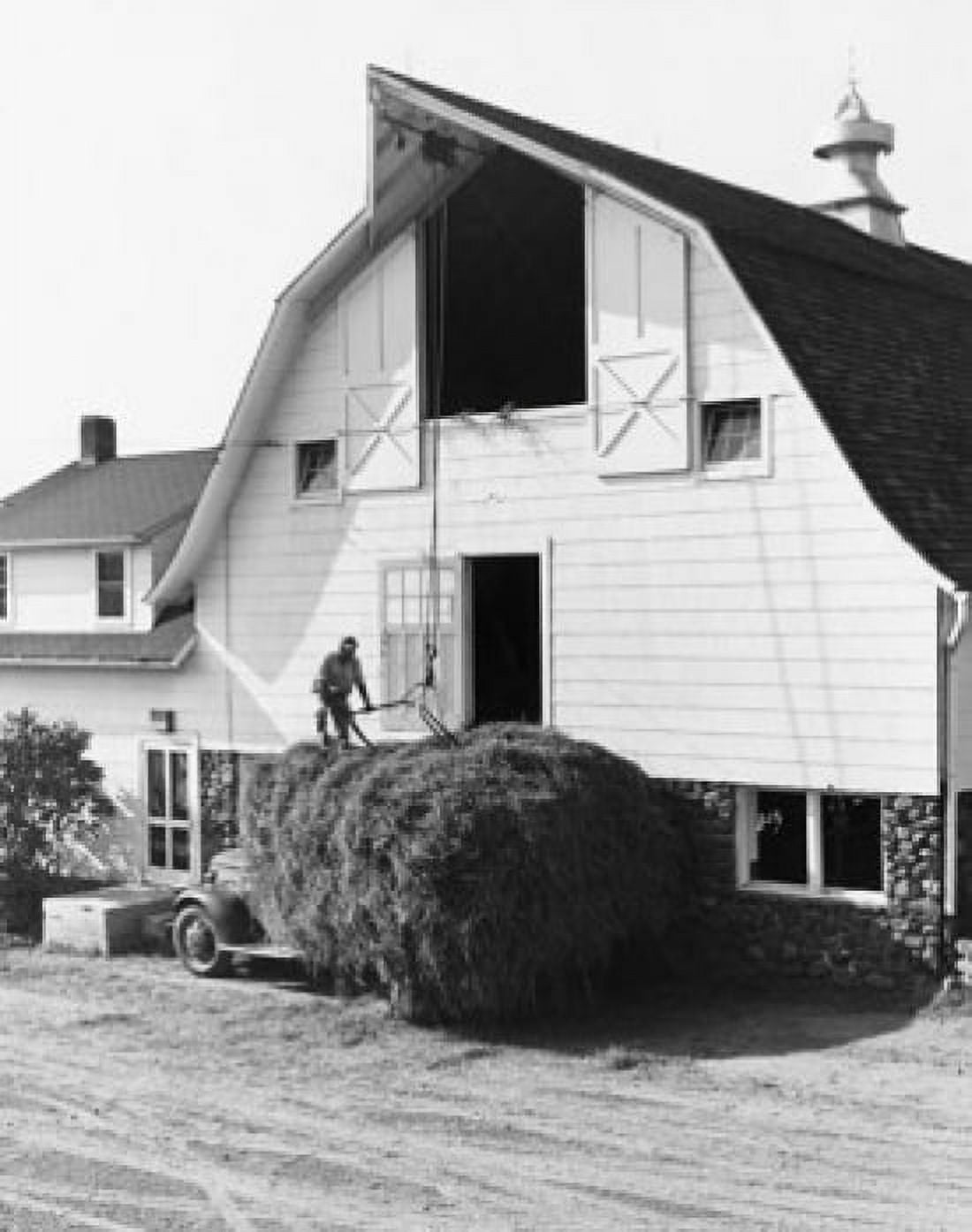 Posterazzi Man storing hay in a barn Canvas Art - (24 x 36)