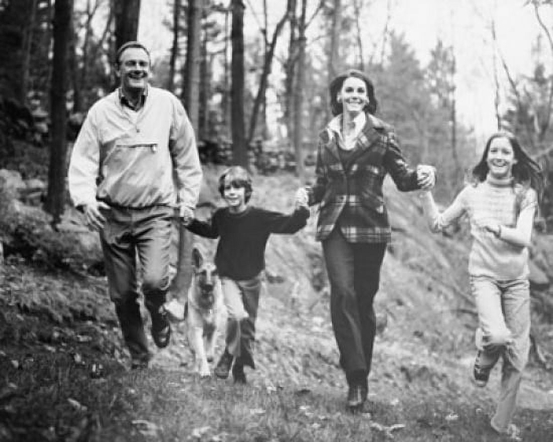 Posterazzi Mature couple holding hands with their two children and running Canvas Art - (24 x 36)