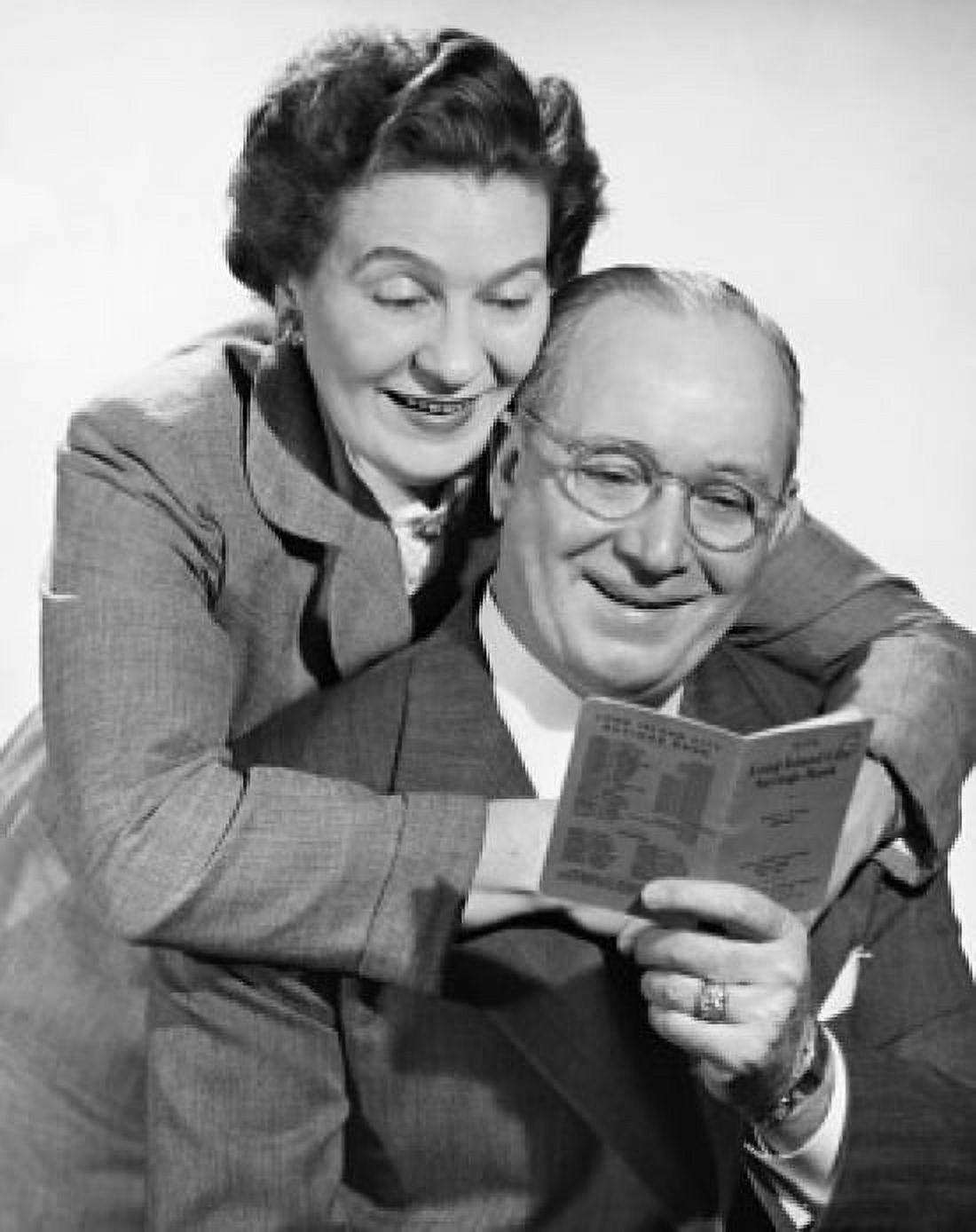 Posterazzi Mature couple looking at a bankbook and smiling Canvas Art - (24 x 36)