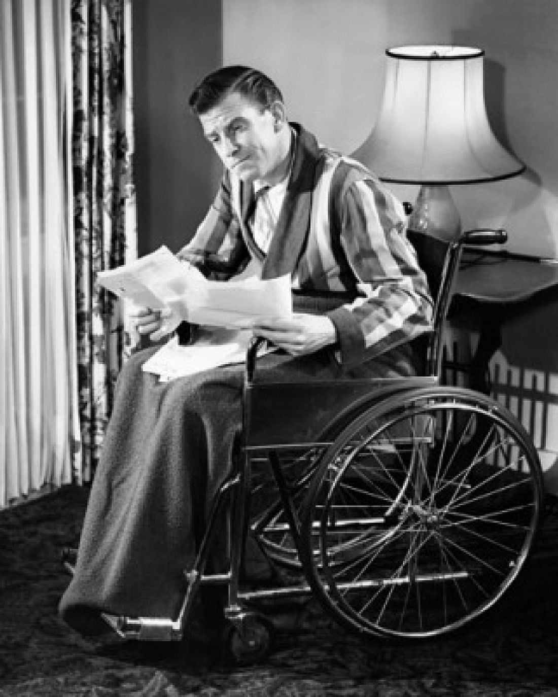 Posterazzi Mature man sitting in a wheelchair and reading documents Canvas Art - (24 x 36)