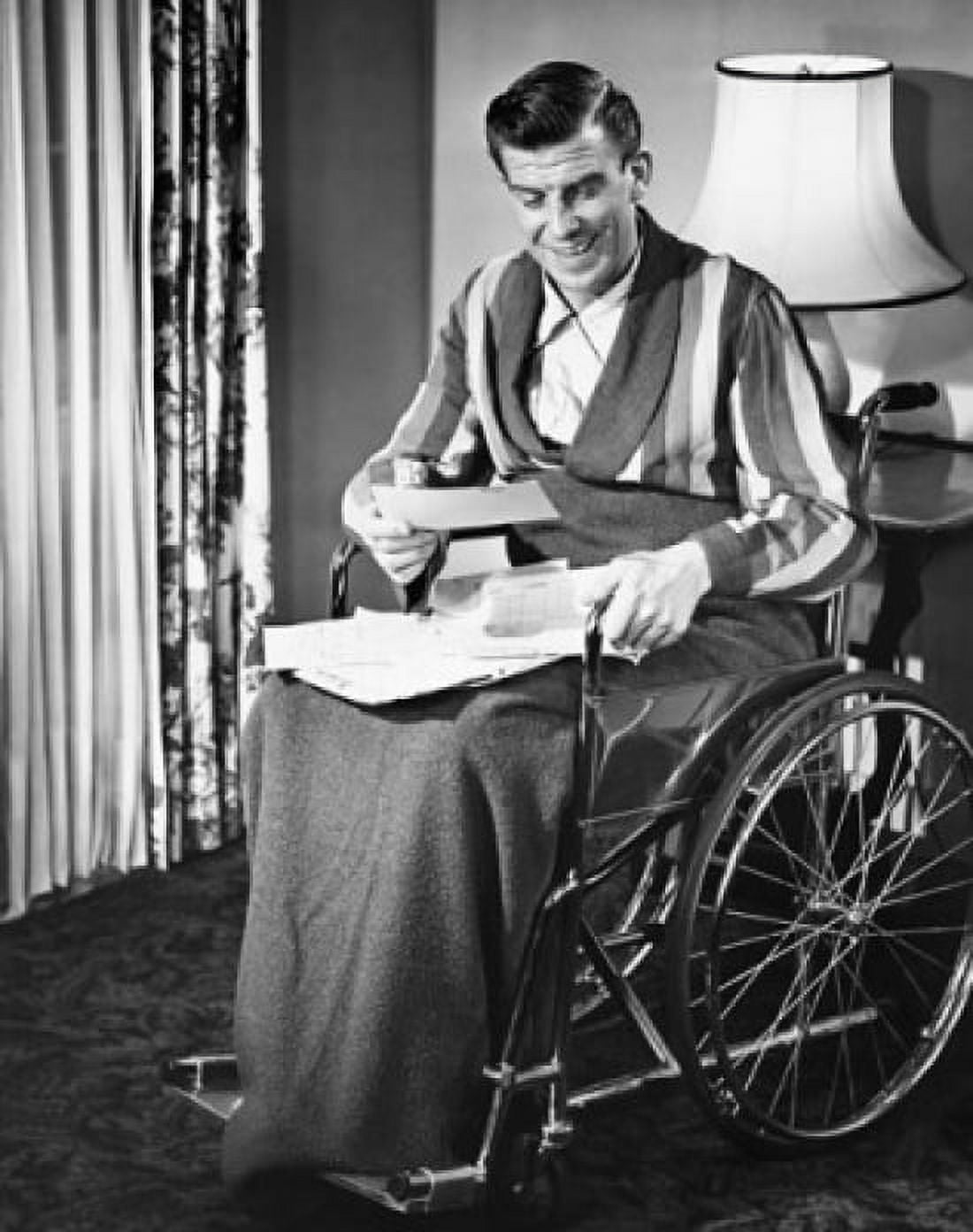 Posterazzi Mature man sitting in a wheelchair and reading documents Canvas Art - (24 x 36)