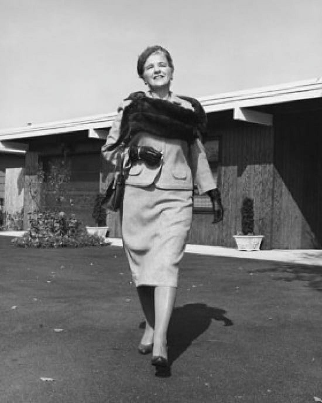 Posterazzi Mature woman walking in front of a house and smiling Canvas Art - (24 x 36)