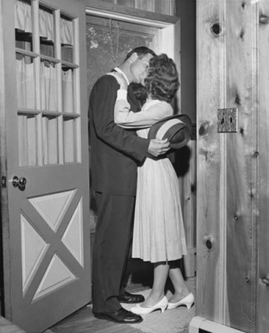 Posterazzi Mid adult couple kissing each other in a doorway Canvas Art -  (24 x 36)