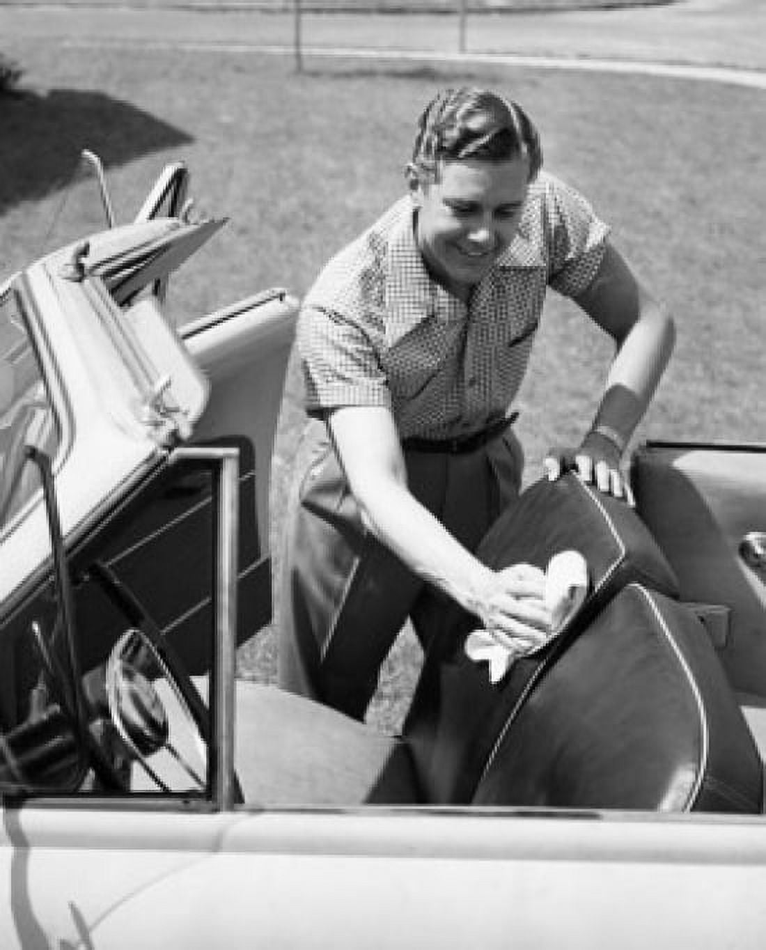 Posterazzi Mid adult man cleaning his car seat with a rag Canvas Art - (24 x 36)