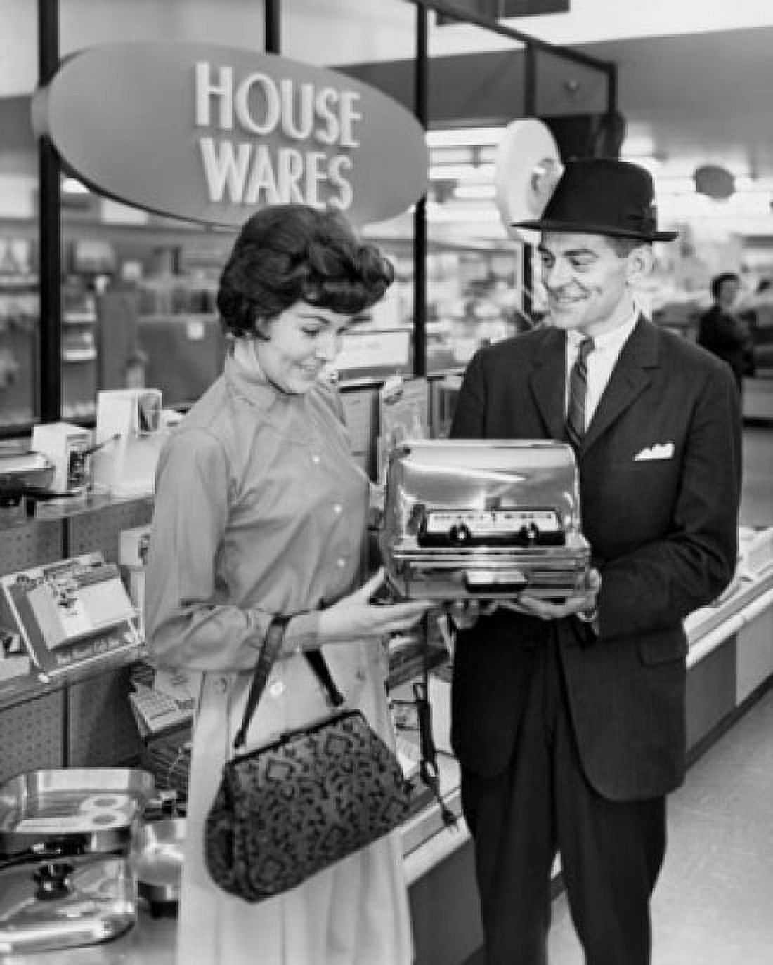 Posterazzi Mid adult man showing a toaster to a mid adult woman Canvas Art -  (24 x 36)