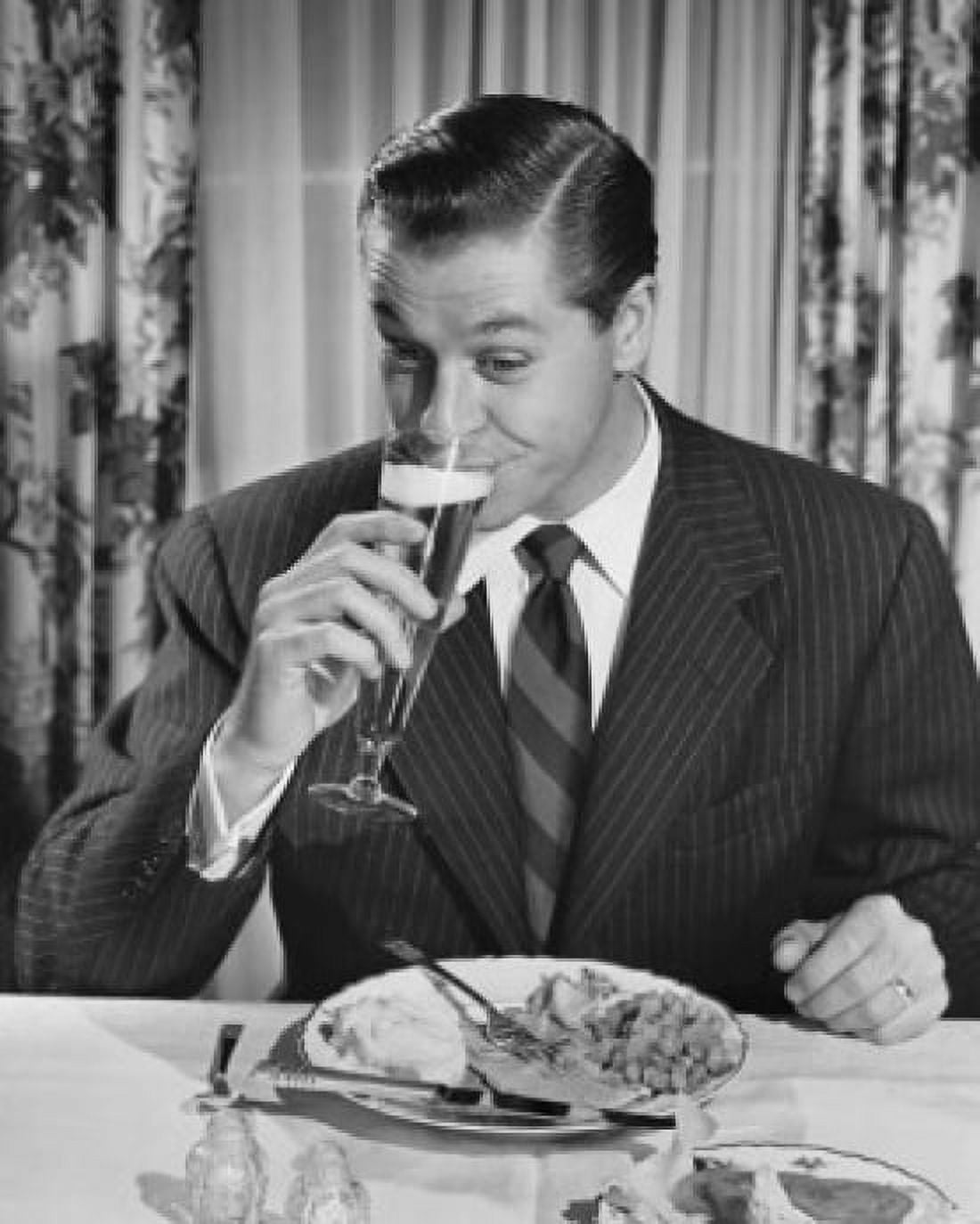 Posterazzi Mid adult man sitting at table drinking beer Canvas Art - (24 x 36)