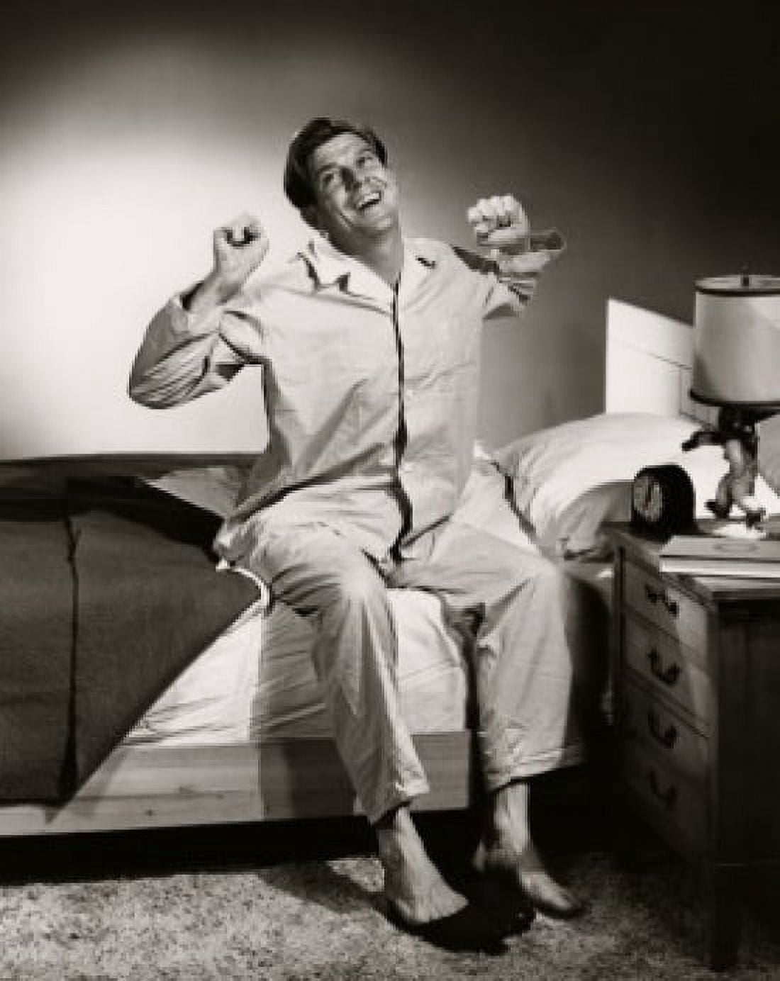 Posterazzi Mid adult man sitting on the edge of the bed stretching Canvas Art -  (24 x 36)