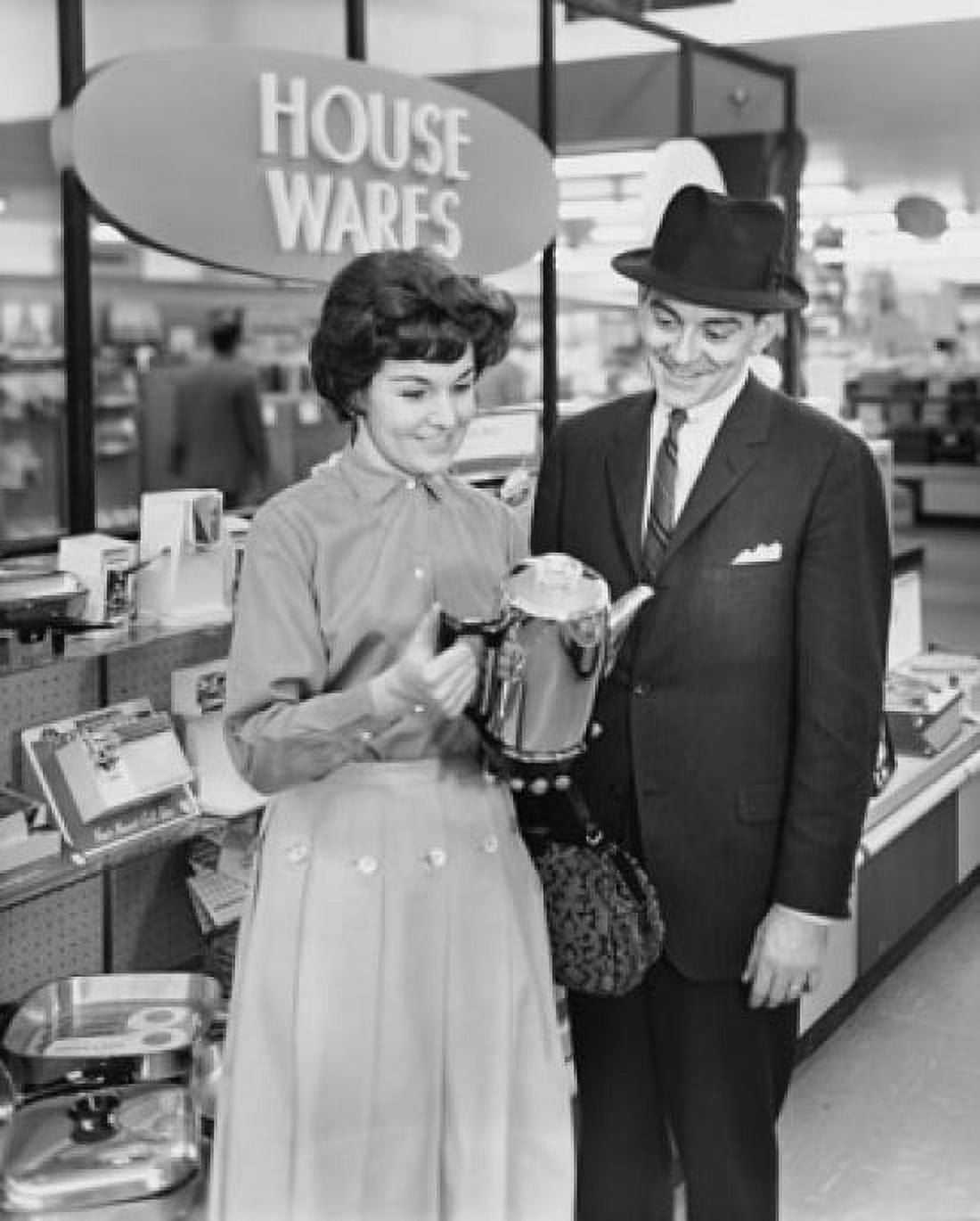 Posterazzi Mid adult woman and a mature man looking at a kettle in a store Canvas Art - (24 x 36)