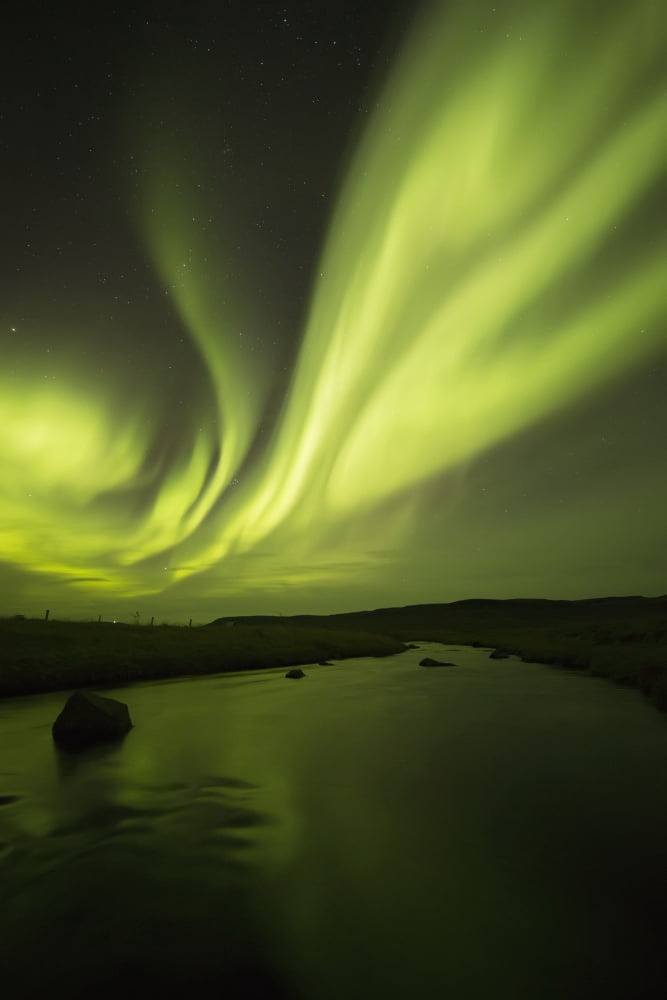 Posterazzi Northern Lights or Aurora Borealis glowing over a stream Iceland Canvas Art - Robert Postma Design Pics (24 x 38)