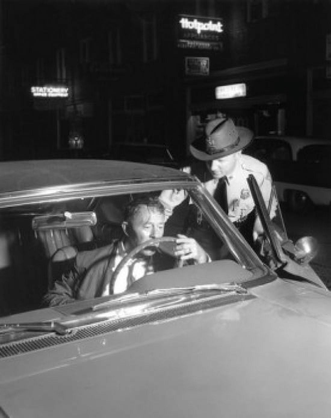 Posterazzi Police officer opening door of car with drunken driver inside Canvas Art - (24 x 36)