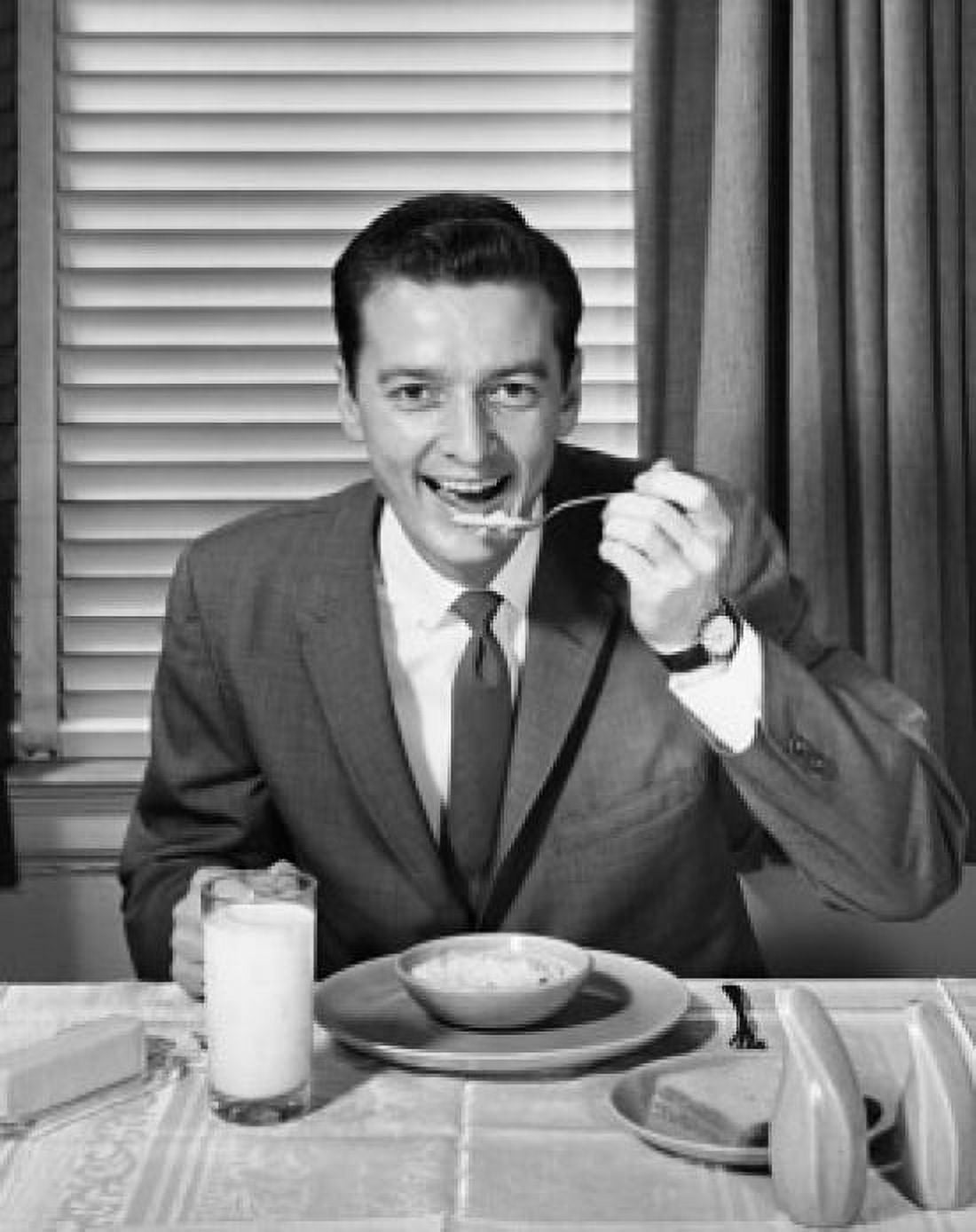 Posterazzi Portrait of a businessman eating breakfast Canvas Art - (24 x 36)
