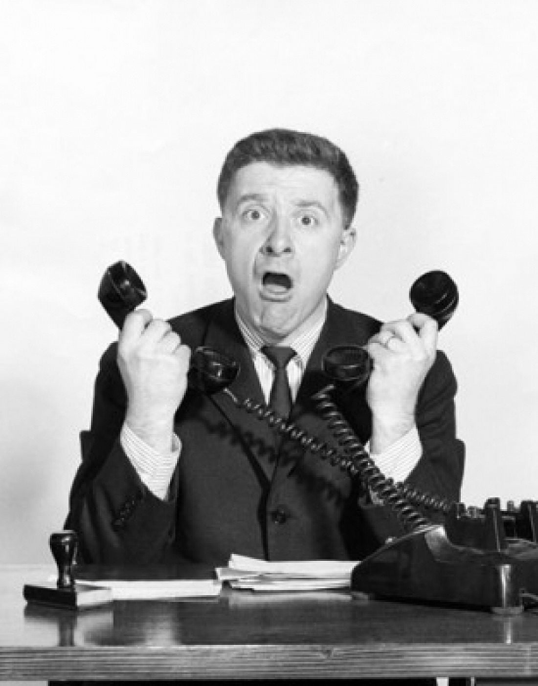 Posterazzi Portrait of a businessman using two telephones Canvas Art - (24 x 36)