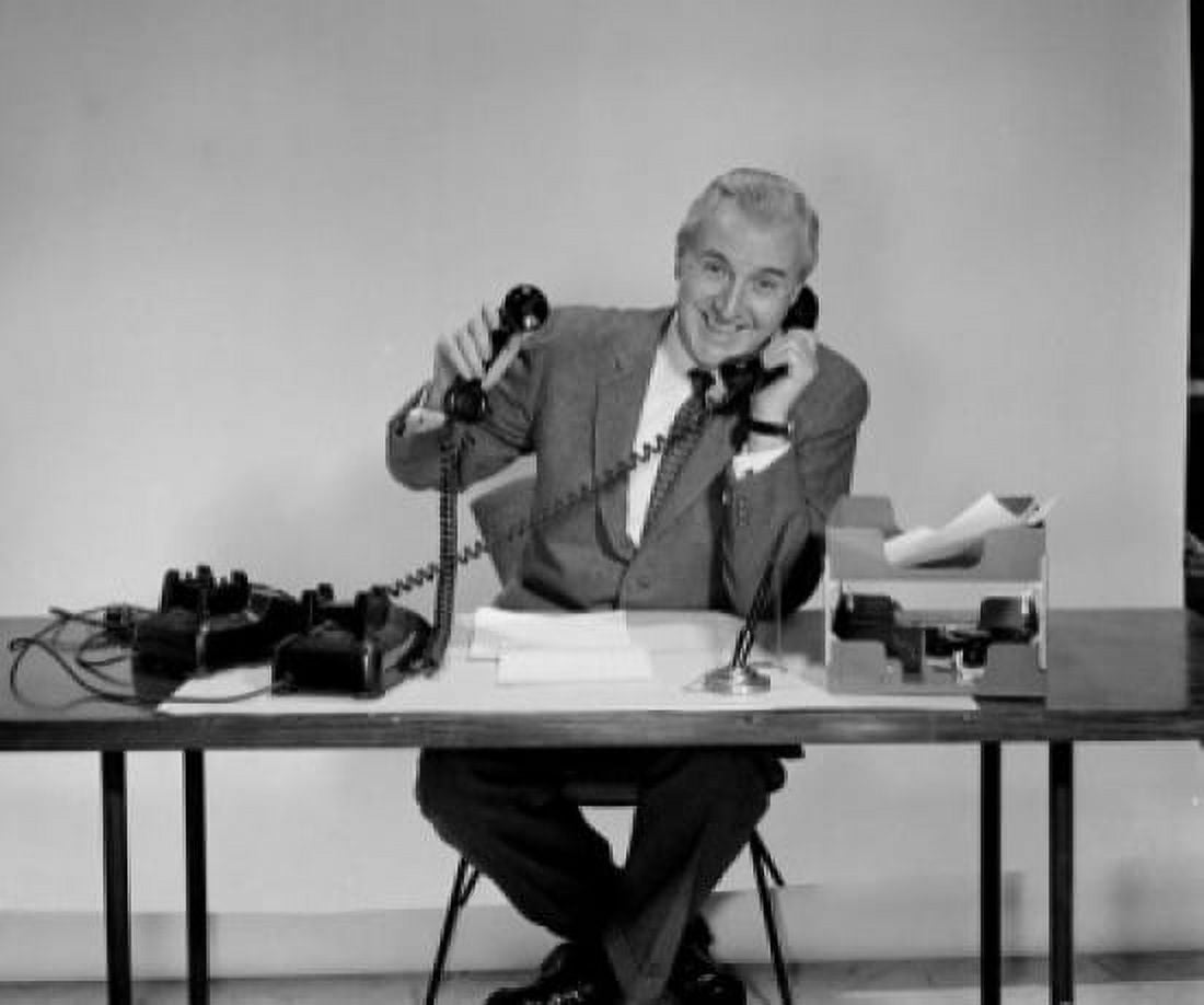 Posterazzi Portrait of a businessman using two telephones Canvas Art - (24 x 36)