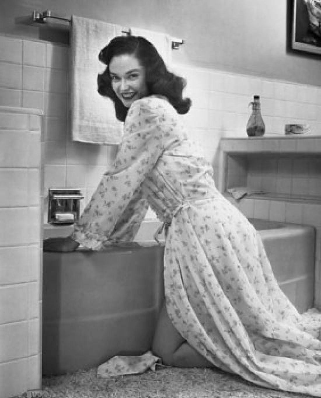 Posterazzi Portrait of a young woman bending over a bathtub in the bathroom Canvas Art - (24 x 36)