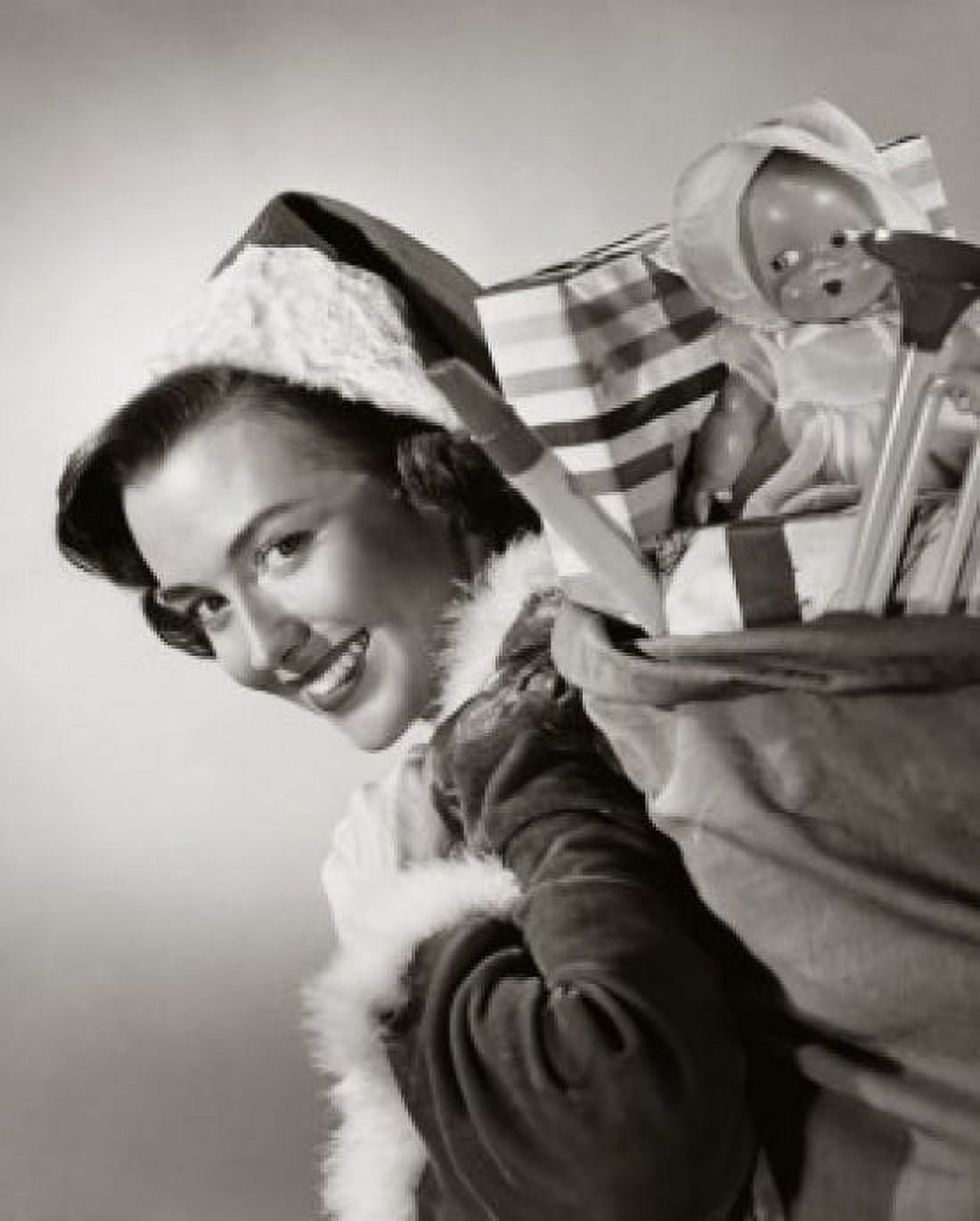 Posterazzi Portrait of a young woman carrying a sack of Christmas presents on her back Canvas Art - (24 x 36)
