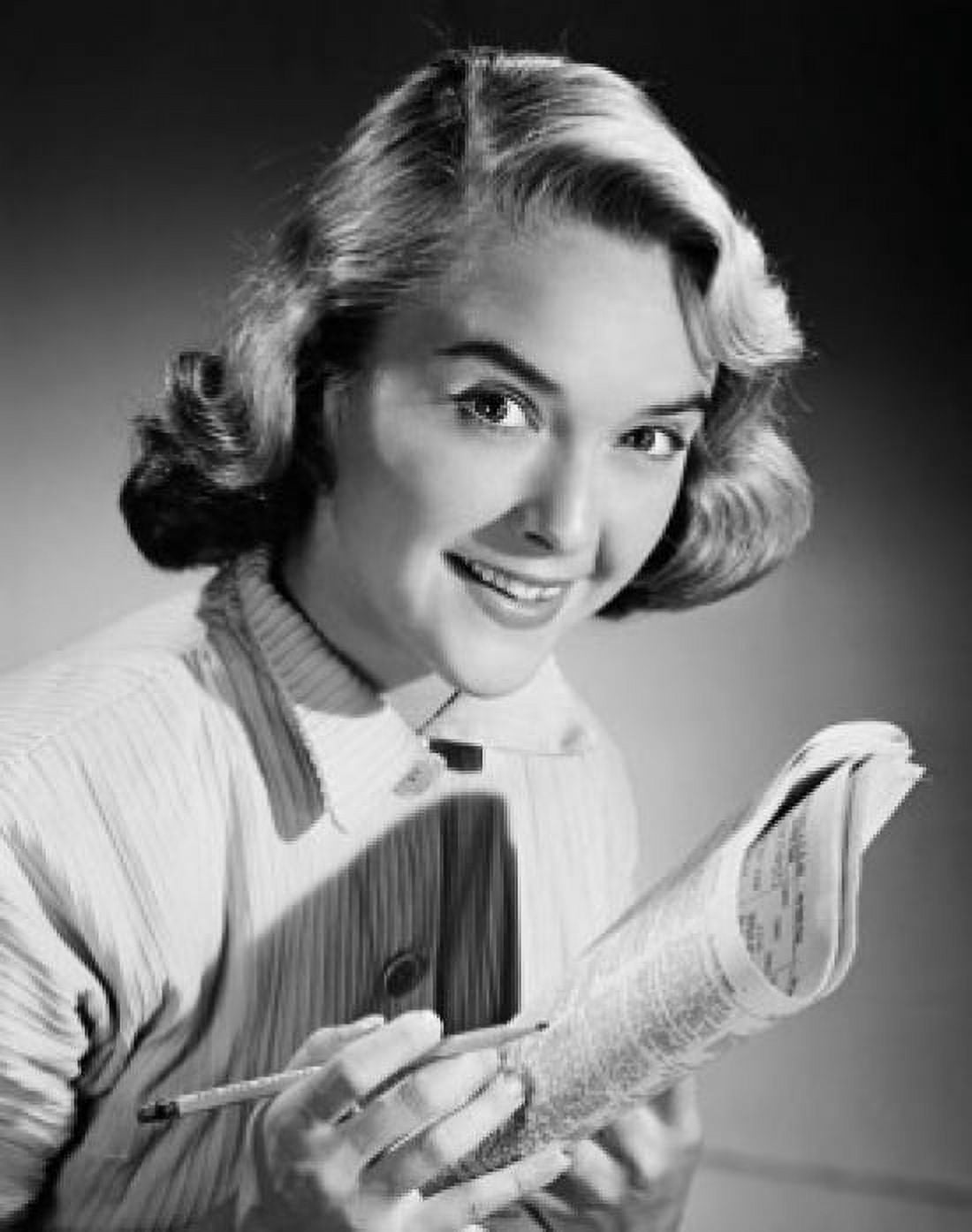 Posterazzi Portrait of a young woman smiling holding a newspaper Canvas Art - (24 x 36)