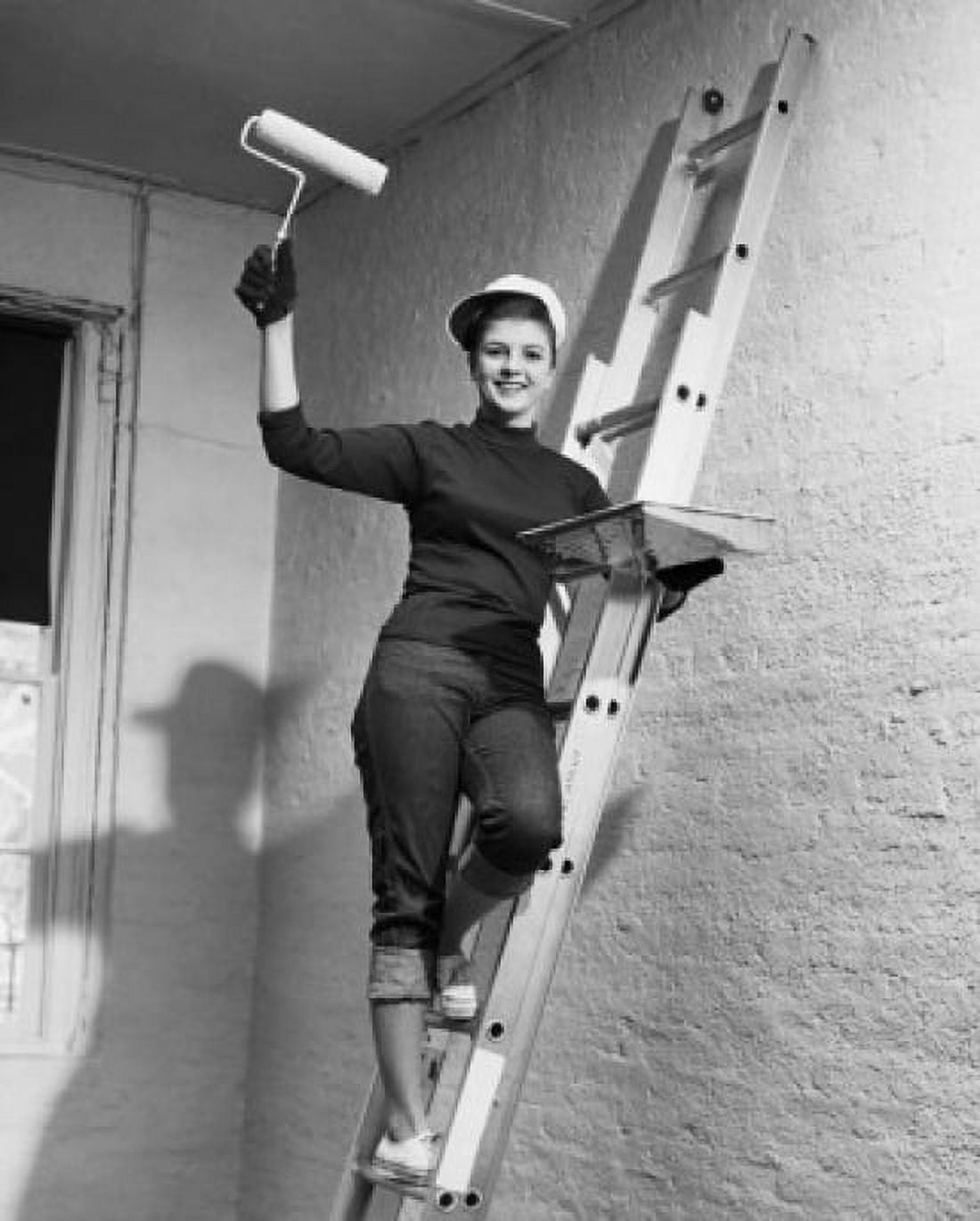 Posterazzi Portrait of a young woman standing on a ladder and holding a paint roller and a paint tray Canvas Art -  (24 x 36)